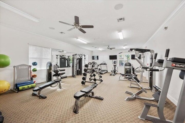 gym featuring a textured ceiling, ceiling fan, and ornamental molding