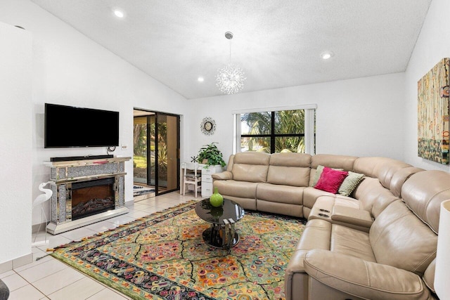 living room featuring light tile patterned flooring, a healthy amount of sunlight, vaulted ceiling, and a textured ceiling