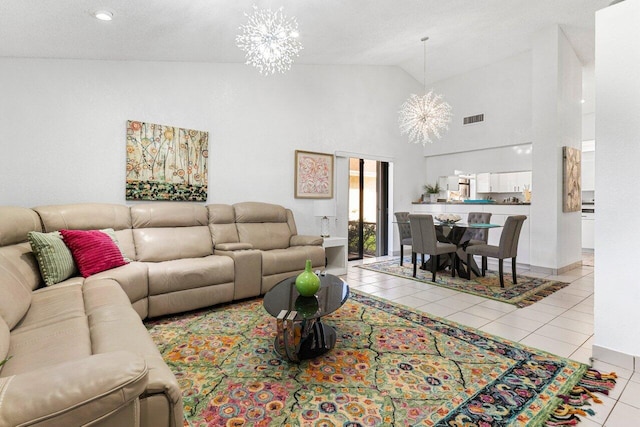 tiled living room featuring an inviting chandelier and high vaulted ceiling