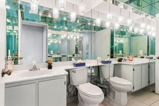 bathroom with vanity, tile patterned flooring, and toilet