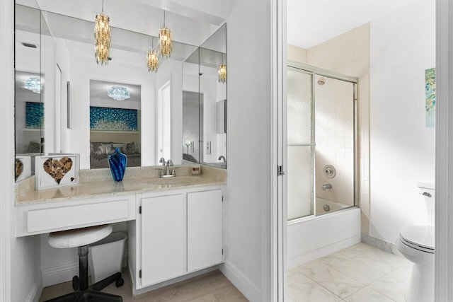 full bathroom featuring toilet, vanity, and bath / shower combo with glass door