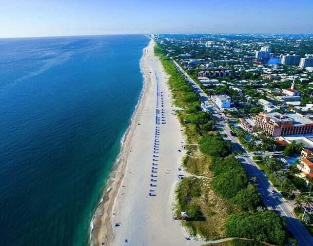 bird's eye view with a water view and a beach view