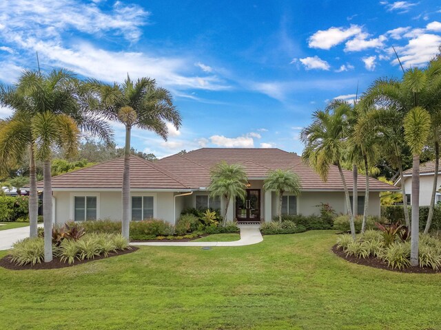 single story home featuring stucco siding and a front yard