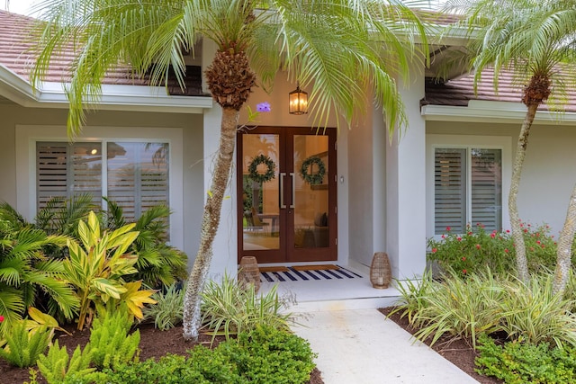 property entrance with french doors and stucco siding