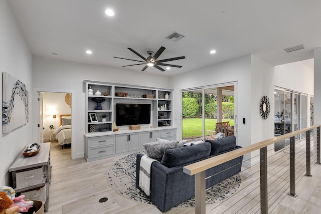 living room featuring ceiling fan and light wood-type flooring