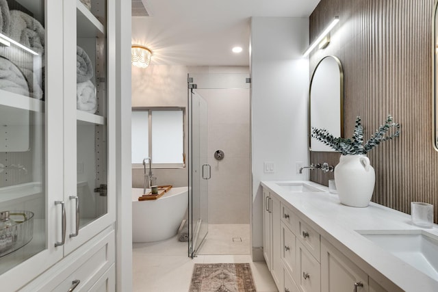 bathroom featuring tile patterned flooring, vanity, and separate shower and tub