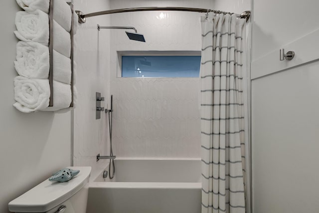 bathroom with shower / bath combo and toilet