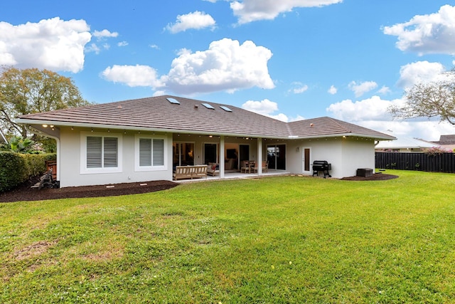 back of house with a yard and a patio area