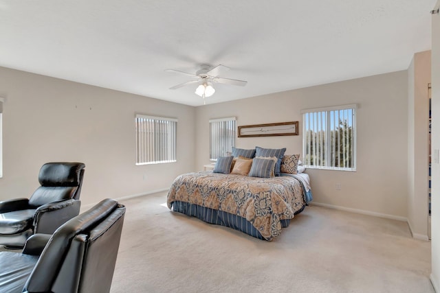 bedroom with ceiling fan and light colored carpet