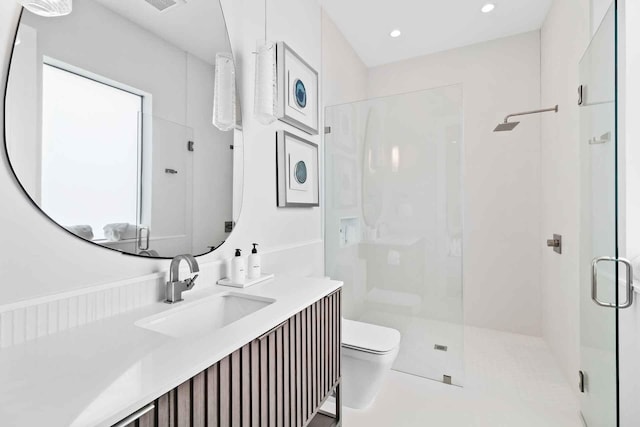 bathroom featuring toilet, tile patterned flooring, a shower with shower door, and vanity