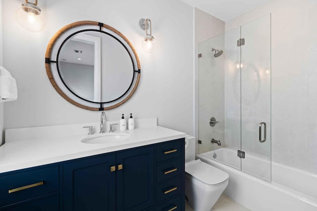 full bathroom with toilet, vanity, and bath / shower combo with glass door