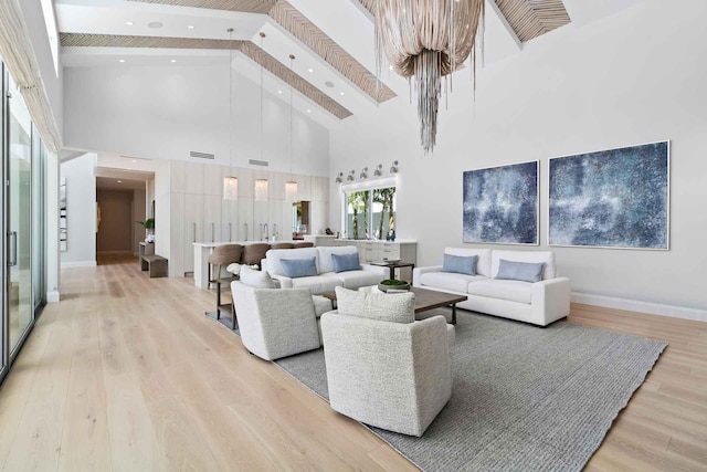 living room featuring a high ceiling and light hardwood / wood-style floors