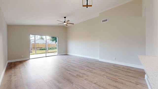 unfurnished living room featuring light hardwood / wood-style floors, ceiling fan, and vaulted ceiling