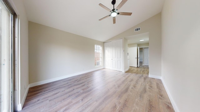 unfurnished room featuring light hardwood / wood-style floors, lofted ceiling, and ceiling fan