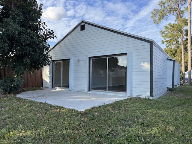 back of house featuring a yard and a patio