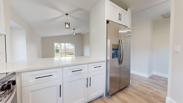 kitchen with ceiling fan, lofted ceiling, stainless steel appliances, and white cabinetry