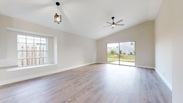 unfurnished room featuring ceiling fan, vaulted ceiling, and light hardwood / wood-style flooring