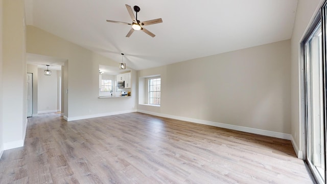 unfurnished living room featuring ceiling fan, lofted ceiling, and light hardwood / wood-style flooring