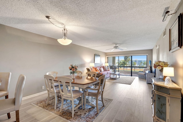 dining room featuring hardwood / wood-style floors, a textured ceiling, and ceiling fan