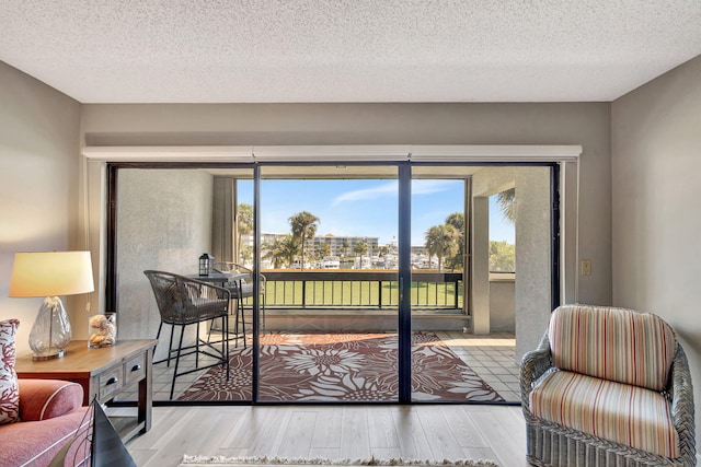 interior space with light hardwood / wood-style flooring and a textured ceiling