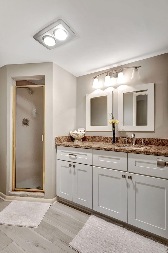 bathroom with vanity, hardwood / wood-style floors, and an enclosed shower