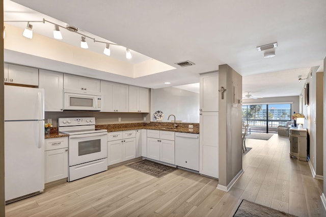 kitchen with white cabinetry, sink, white appliances, and light hardwood / wood-style floors