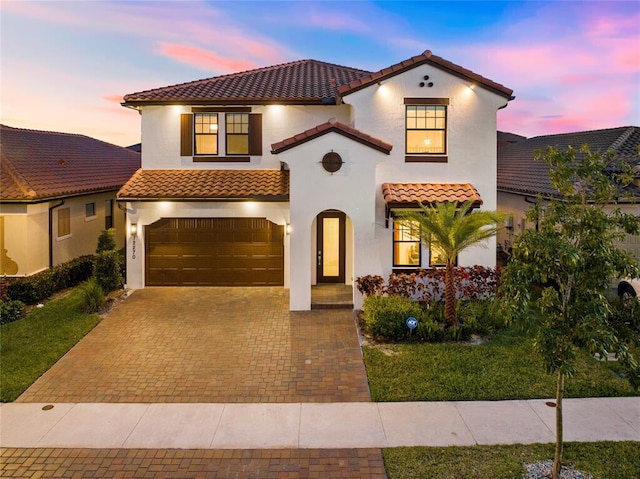 mediterranean / spanish-style house featuring a garage