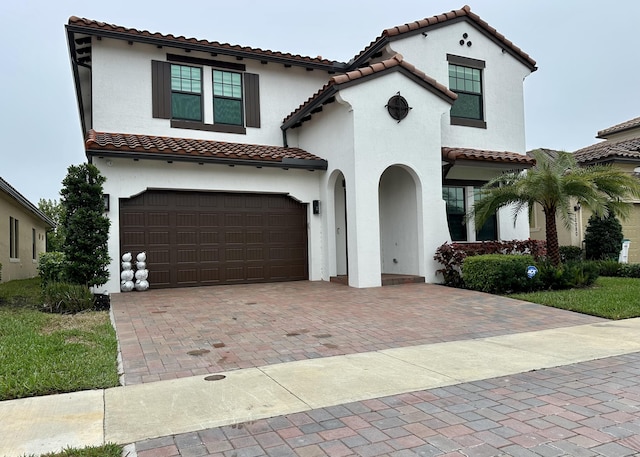 mediterranean / spanish-style home with a garage