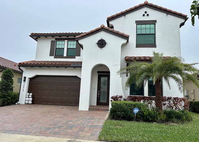 mediterranean / spanish house featuring a garage