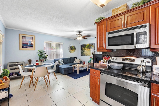 kitchen featuring a textured ceiling, stainless steel appliances, backsplash, ornamental molding, and light tile patterned flooring