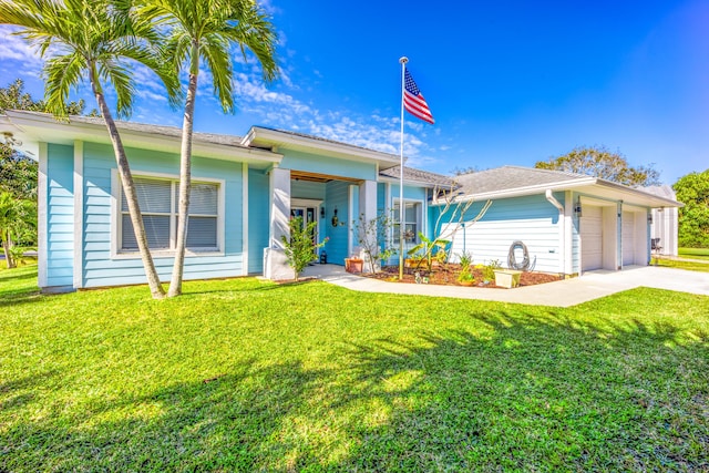 view of front of house with a front yard and a garage