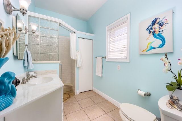 bathroom featuring toilet, vanity, tile patterned flooring, and a shower with shower curtain