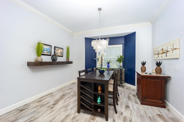 dining room with a notable chandelier, ornamental molding, and light hardwood / wood-style floors