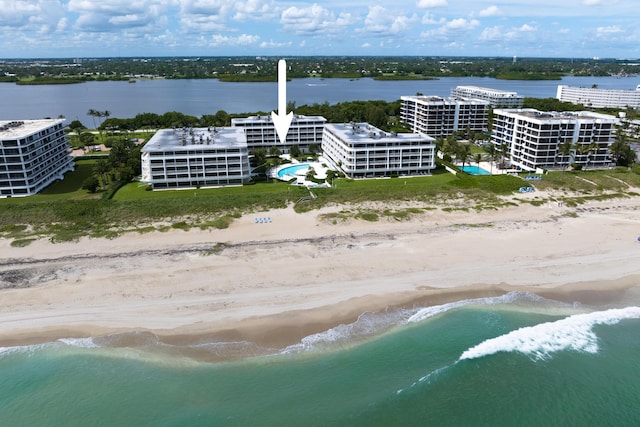 drone / aerial view with a water view and a view of the beach