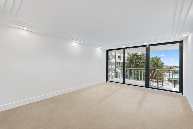 bedroom featuring a wall of windows and access to exterior