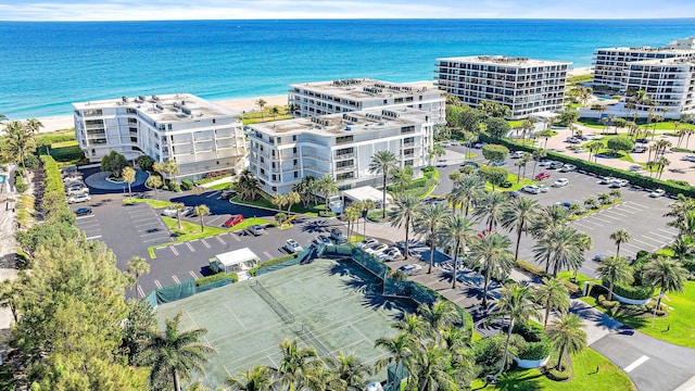 birds eye view of property featuring a water view and a view of the beach