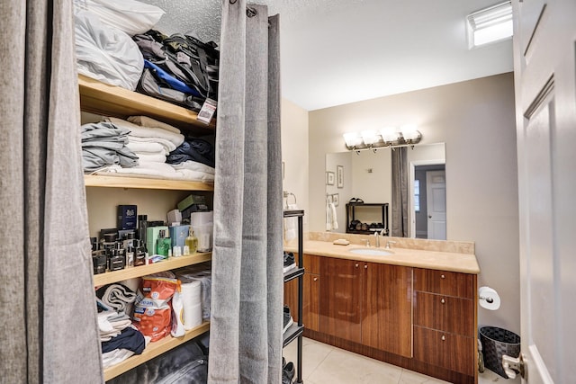 bathroom featuring tile patterned flooring and vanity