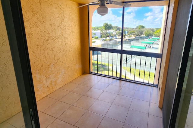 unfurnished sunroom with ceiling fan