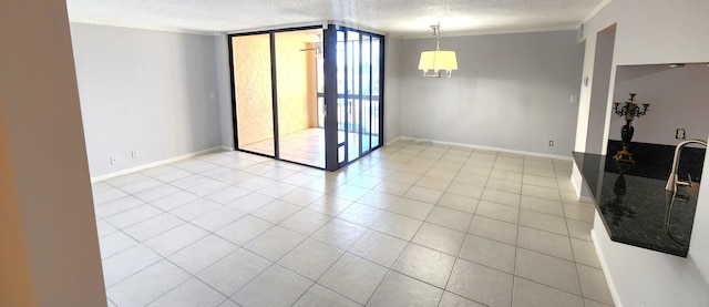 tiled empty room featuring a wall of windows and a textured ceiling