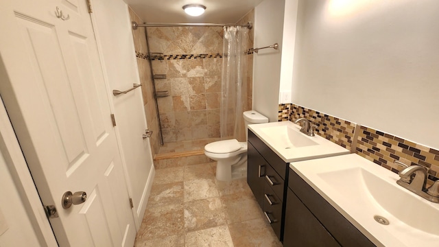 bathroom with toilet, a shower with curtain, vanity, and decorative backsplash