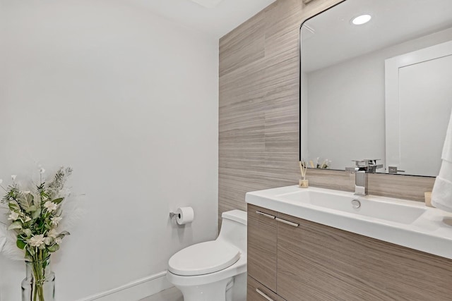 bathroom featuring toilet and vanity