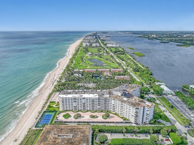 drone / aerial view with a water view and a beach view