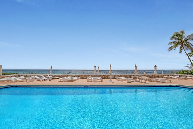 view of pool with a water view