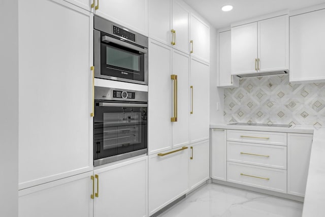 kitchen featuring tasteful backsplash, white cabinets, and black electric cooktop