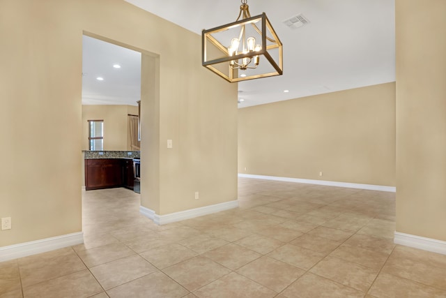 unfurnished dining area featuring light tile patterned floors and a notable chandelier