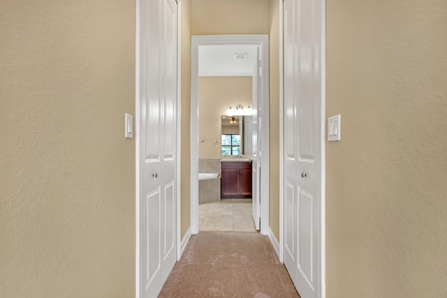 corridor featuring light carpet