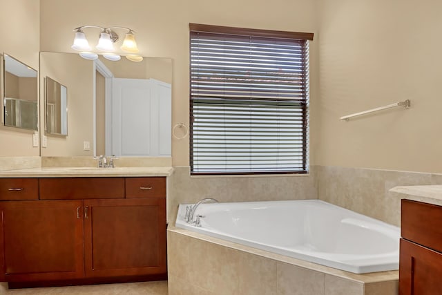 bathroom with vanity, tile patterned floors, and tiled tub