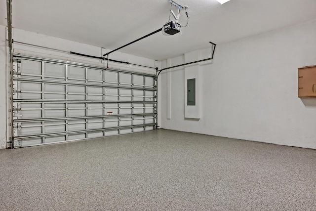 garage with a garage door opener and electric panel