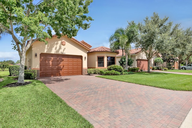 mediterranean / spanish home with a garage and a front yard