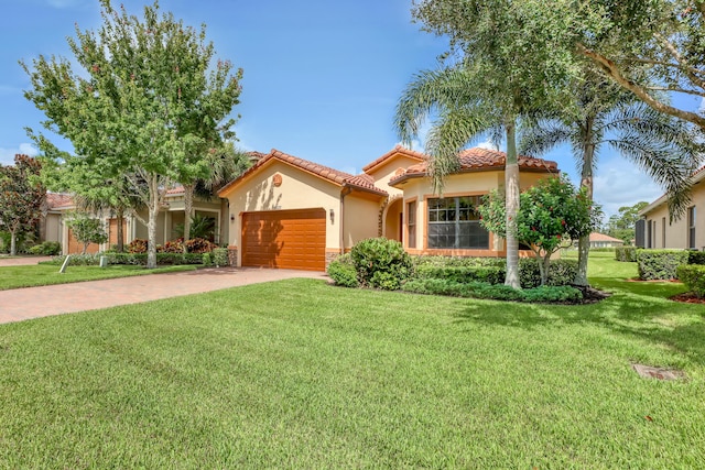 mediterranean / spanish-style home with a front yard and a garage